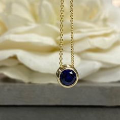 "The pendant pictured is lab created blue sapphire shown in both 14k yellow gold and 14k white gold#5871 The chain is non removable -Approximate total carat weight: approx. .80ctw diamond equivalent -Center Stone Size: 6mm - approx. .80ct diamond equivalent -Center Stone Shape: round -Gem Type: lab created sapphire -Stone Clarity: VS2 -Stone Color: Blue -Moh's Scale: 9 hardness -Metal Type and Purity: 14k white gold -Setting: bezel set floating necklace -Chain: 18\" delicate 14k gold chain / hea Blue Sapphire Pendant, Sapphire Necklace Pendants, Travel Necklace, Floating Necklace, Pear Shaped Engagement Rings, Bezel Necklace, Golden Necklace, Engagement Ring Shapes, Inspo Pics