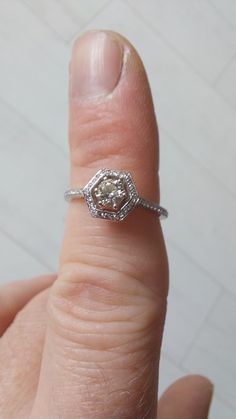 a close up of a person's finger with a ring on it