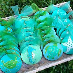 some green and blue decorated eggs in a basket