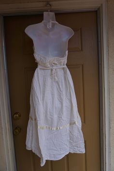 A fun summery Mexican fiesta dress in white with purple floral embroidery. Styling perfect for warm sunny days. No tags found. Please refer to measurements below for sizing. Estimated size L. Condition - has a light yellow spot shown in last phtoto (hardly noticeable). MEASUREMENTS (taken with the garment laying flat) Underarm to underarm- 18 inches Empire Waist- 15.5 inches across front Length: 37 inches from armpit to hem Summer Embroidered Cotton Maxi Dress, Embroidered Cotton Maxi Dress For Summer, Summer Sundress With Floral Embroidery For Beach, White Cotton Halter Neck Maxi Dress, Embroidered Summer Sundress For Vacation, Embroidered Cotton Maxi Dress For Beach, Embroidered Fitted Beach Sundress, Fitted Embroidered Beach Sundress, Embroidered Fitted Sundress For Beach