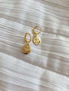 super cute Gold-Plated Smiley Face huggie hoop earrings! Hypoallergenic & perfect for everyday wear! 💍 Material: - gold-plated brass leverback - lightweight - hypoallergenic (lead & nickel free) 📦 Shipping & Returns: - Earrings are made to order, it could sometimes take more than a week if I run out of the supplies. In that case, I will reach out & let you know! - Since the item is made to order, I am not able to accept returns. - Please contact me if you have any problems with your order, I'd be happy to work something out 🍒 All items are designed and handmade by GS Creative Design Cute Nickel-free Round Hoop Earrings, Fun Nickel-free Everyday Earrings, Nickel Free Fun Earrings For Everyday, Fun Nickel-free Earrings For Everyday, Cute Adjustable Huggie Earrings, Cute Everyday Nickel-free Earrings, Cute Everyday Earrings For Pierced Ears, Cute Hypoallergenic Round Hoop Earrings, Fun Adjustable Hoop Earrings As Gift