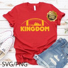 a t - shirt that says kingdom with a football on the front and city skyline in yellow