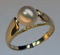 Our lovely 14k yellow gold cultured pearl solitaire ring has a 7mm pearl center. The simplicity of this 14k yellow gold pearl ring is what makes it so beautiful. SKU: 0159 Item: Cultured Pearl Solitaire Ring  Stone Weight: 7mm Pearl  Gold: 14kt Yellow Length: 1/4" Formal Solitaire Pearl Ring In Yellow Gold, Elegant Gold Solitaire Pearl Ring, Luxury White Solitaire Pearl Ring, Classic 14k Gold Solitaire Pearl Ring, Solitaire Pearl Ring, Fine Jewelry, Gold Pearl Ring, Ring Stone, Gold Pearl, Pearl Ring