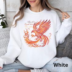 Our fire phoenix sweatshirt features a stunning design symbolizing the fire within you. Stay cozy and stylish with this unique piece that is sure to turn heads wherever you go. Elevate your wardrobe with this Fire Phoenix sweatshirt, capturing the essence of the sky above, the earth below, and the fire within. Made with high-quality materials for ultimate comfort, this sweatshirt will add a touch of magic to your everyday look. Unleash your inner Fire Phoenix with this beautiful shirt. Ideal for Rise From The Ashes, Bird Shirt, Phoenix Bird, Graphic Sweaters, Sweatshirt For Women, Stay Cozy, Cut And Style, Everyday Look, San Jose