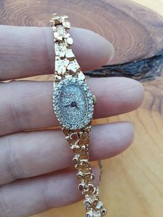 "ATTENTION BUYERS.. PLEASE READ ANNOUNCEMENT IN MY SHOP. it's very important information there about purchasing items. Must purchase thru Etsy only, NOT from \" Offsite ads\"Absolutely Stunning 14k Yellow Gold Diamond Lady's Wrist Watch... Perfect Vintage Pre Owned Condition. Watch stamped 14k gold. All appraximately, my Estimate.. I am not Gemologist. All sales are final.. Some pics ENLARGED to see details Weight 25.35 Grams Safety Chain on The Side. For less then 7 inches Wrist.ATTENTION BUYER 14k Gold Round Watches For Formal Occasions, Luxury Hallmarked Diamond Watch For Evening, Luxury Hallmarked Diamond Watch For Evenings, Luxury Gold Jewelry And Watches For Collectors, Luxury Gold Collectible Jewelry And Watches, Luxury Gold Jewelry And Watches Collectible, Yellow Gold Diamond Jewelry And Watches As Gift, Luxury Hallmarked Evening Watches, Gold Diamond Jewelry And Watches For Evening