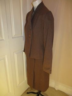 "This sharp suit is by Bert Newman for Suitime. It from from the late 1970's early 80's . It's 80% wool , 20% polyester. The jacket has 2 button side closure offset to one side with an interior snap. The skirt is a mock wrap with a center metal zipper and 2 buttons. The solid fabric is actually multi color tweed. I can see some plum and purple. The coordinating check fabric is on the collar and inside the skirt flap. The jacket has side pockets. No size tag but it is approx. size 2. The jacket m Fitted Skirt Suit For Career In Fall, Tailored Career Skirt Suit With Buttons, Classic Tailored Wool Skirt Suit, Wool Suits For Career, Fall Season, Wool Suits For Career In Fall, Fall Wool Suits For Career, Fall Business Skirt Suit With Notch Lapel, Fall Business Skirt Suit, Single Breasted, Wool Skirt Suit For Formal Fall Events