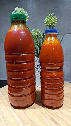 two large bottles sitting on top of a wooden table