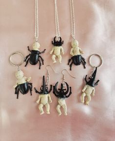 Super cute n creepy mutant beetle babies! Soooo creepycute and pastel goth! Each unique piece is handmade and one of a kind, some beetle babies are more beetle and some are more baby, some have baby bodies and some have bug bodies. They feature pinchers like a stag beetle or rhinocerous beetle, and have creepy beetle-like bodies and legs fusing with the human-like baby body parts. Keychains, necklaces, and earrings available!! Feel free to contact me about switching around the style for example swapping a necklace to a keychain. The beetle baby creatures measure approx 5cm in length. There are several styles available so please refer to the last photo when choosng a style number! :) They are a lovely gift for any pastel goth babe or appreciator of creepycute things! xoxo Quirky Handmade Halloween Jewelry, Cute Handmade Halloween Jewelry, Immaculate Vibes, Jewelry Keychain, Keychain Necklace, Stag Beetle, Creepy Cute, Baby Body, Pastel Goth