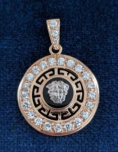 "A well made 14 karat rose gold jewelry ensemble consisting of a pendant with matching earrings for pierced ears set with cubic zirconia. The exception is a .07 carat diamond at the top of the pendant's bail, a replacement stone. The neo-classical design features Greek fret work and 14k white gold lion's faces on top of black onyx rounds. The CZ stones are .05 carats each in the pendant and .03 in the earrings. The pendant measures 1 9/16 inches high, including the bail; it is 1 1/8 in diameter. Fret Work, Gold Lion, Neo Classical, Pendant Bails, Rose Gold Pendant, Rose Gold Jewelry, Cz Stone, Earings Piercings, Matching Earrings