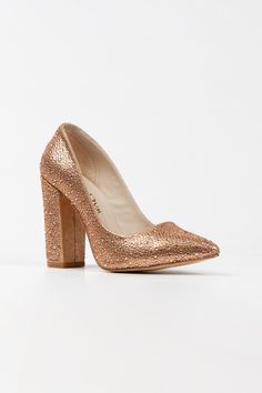 a pair of high heeled shoes with gold glitter finish on the upper and sides