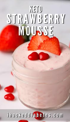 strawberry cheesecake mousse in a glass jar with strawberries around it and text overlay reading keto strawberry mouse