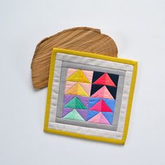 a piece of wood sitting on top of a table next to a patch of fabric