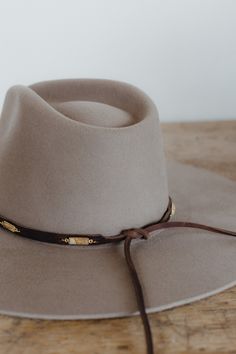 These unique bands feature 3/8" chocolate brown grizzly leather with gemstones attached by hand approximately every 2 inches. Leather ties in back make them adjustable to any hat size. Material: Genuine grizzly leather Hardware: Jasper stones, silver or gold jump rings Dimensions: 34" total length, 22" band length with stones before adjustable tie closure. Closure: Leather ties Cheap Brown Hat Bands For Men, Luxury Everyday Brimmed Hat Bands, Luxury Flat Brim Hat Bands For Spring, Luxury Wool Hat Band With Flat Crown, Luxury Rustic Hat Bands For Men, Luxury Adjustable Wool Hat Band, Luxury Woven Brimmed Hat Bands, Luxury Fitted Hat Bands For Fall, Cheap Vintage Flat Brim Hat Bands