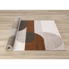 a rug on the floor with a roll of carpeting next to it and an area rug