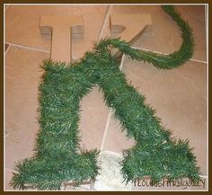 the letter k is made out of fake grass and has been placed on the floor