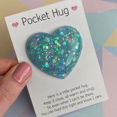 a heart shaped brooch sitting on top of a card