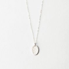 Our most popular oval pendant, without personalization. Choose a smooth, or hand-hammered texture. Elegant Hammered Oval Necklace, Elegant Oval Hammered Necklace, Elegant Hammered Oval Pendant Necklace, Silver Hammered Oval Pendant Necklace, Hammered Sterling Silver Oval Link Jewelry, Modern Hammered Necklace With Round Pendant, Silver Hammered Oval Pendant Jewelry, Elegant Hammered Oval Pendant Jewelry, Modern Hammered Oval Link Jewelry