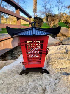 a red lantern sitting on top of a rock