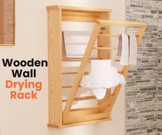 the wooden wall drying rack holds folded towels