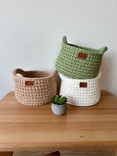 three baskets sitting on top of a wooden table