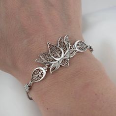 The serenity of Spirit Filigree Sterling Silver Lotus Flower Woman Link Bracelet - Handcrafted Sterling Silver Jewelry Revel in Our Meticulously Handcrafted Filigree Lotus Bracelet Honoring the bloom's symbol of spiritual serenity through masterful artistry. Graceful sterling silver filigree seamlessly fuses into a charming lotus motif, celebrating its essence of tranquility and enlightenment. Thoughtfully Designed for Adjustable Wear This bracelet beautifully accommodates wrists of all sizes wi Silver Jewellery Design, Money Crown, Lotus Motif, Lotus Flower Jewelry, Silver Bracelet Designs, Silver Bracelet For Women, Flower Woman, Lotus Bracelet, Lotus Flower Design