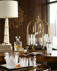 a table topped with glasses and an open book