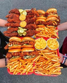 a large tray filled with lots of hot dogs and other foods on top of it