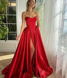 Ruby Luminescence Pleated Gown | Teuta Matoshi Glamorous Strapless Prom Ball Gown, Glamorous Formal Ball Gown With Corset Back, Floor-length Gown For Debutante Ball Gala, Glamorous Strapless Gown For Debutante Ball, Glamorous Strapless Ball Gown With Sweep Train, Glamorous Ball Gown For Debutante Ball, Glamorous Gown With Sweep Train And Fitted Bodice, Glamorous Satin Ball Gown For Prom, Glamorous Satin Ball Gown For Prom Season