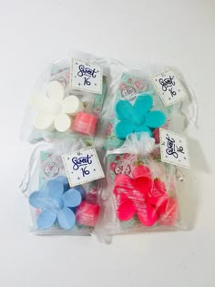 four bags filled with different colored bows