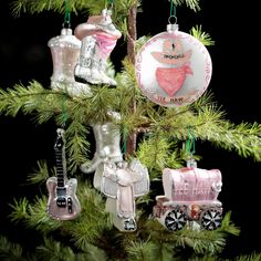 an ornament hanging from a christmas tree with musical instruments on it's ornaments