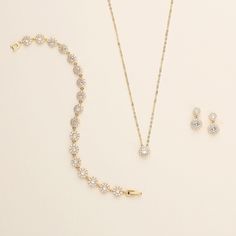 "This sparkling round halo gold wedding jewelry set will surely add brilliance to your special day! This earrings and necklace set is perfectly matched with clear AAA grade prong set cubic zirconia in a single round framed design. Perfect for the bride or makes a great bridesmaid jewelry gift!   DETAILS * High quality cubic zirconia.  * Earrings measure 1/2 inches. (pierced or clip-ons) * Necklace is adjustable from 16 inches to 18 inches long, pendant measures 8mm. * Perfect for brides, bridesm Elegant Gold Jewelry With Halo Design, Gold Cubic Zirconia Round Bridal Sets, Gold Crystal Jewelry With Prong Setting, Gold Crystal Jewelry Sets, Wedding Gold Jewelry With Halo Design, Gold Halo Design Wedding Jewelry, Gold Halo Design Jewelry For Wedding, Elegant Gold Bridal Sets With Halo Setting, Elegant Gold Jewelry With Halo Setting