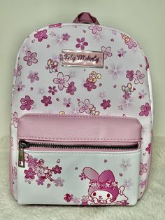 My Melody Cherry Blossom Mini Backpack Take a moment to stop and smell the cherry blossoms with your Sanrio bestie! Get ready for spring with this supercute mini backpack, featuring My Melody and cherry blossom designs. Comes with adjustable straps, an interior zipper pocket and top carrying handle. 8'' x 4'' x 11 1/2'' Polyurethane Adjustable straps Interior zipper pocket Top carrying handle Imported       ** Don't forget to check out our other mini backpacks! ** We DO NOT accept returns on backpacks. Please look at all pictures and feel free to ask any questions. Thank you!! Sakura Flowers, Pink Sakura, Sanrio My Melody, Mini Backpacks, Plush Backpack, Blossom Design, Pink Backpack, Pocket Top, My Melody