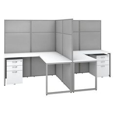 an office cubicle with two desks and three drawers