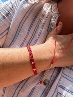 Elevate your style with this delicate red macrame bracelet featuring shimmering gold star accents and a round hook closure. Perfectly tiny yet eye-catching, this bracelet makes an ideal gift for her birthday or any special occasion. The vibrant red and gold combination adds a touch of elegance and charm to any outfit Item Details: 20cm long Handcrafted with care Ships from Virginia Ready to ship in one day Packaged with protective material to prevent any damage during the shipment Star-shaped Red Bracelets As Gifts, Red Star-shaped Bracelet For Gift, Red Macrame Braided Bracelet As Gift, Red Macrame Braided Bracelet For Gift, Tiny Bracelet, Hook Bracelet, Diy Weaving, Gift For Her Birthday, Wedding Jewelry Bracelets