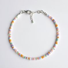 Our multicoloured beaded bracelet with dainty glass beads in pinks, white, blue, aqua, oranges, lilac and green and a sterling silver lobster clasp and extension chain is the perfect summer holiday bracelet. Each bracelet measures 6.5in and extends to 7.5in. It's super lightweight and so comfy to wear. Delivered in our pretty gift box, so fantastic as a present for a friend or to yourself! Matching necklace https://www.etsy.com/uk/listing/1752503310/multi-colour-summer-beaded-choker? Matching an Adjustable Multicolor Pearl Bracelet With Colorful Beads, Pastel Colorful Beads Bracelets As Gift, Pastel Bracelets With Colorful Beads For Gift, Pastel Colorful Beads Bracelet As Gift, Adjustable Pastel Beaded Bracelet, Pastel Beaded Bracelets As Gift, Dainty Multicolor Beaded Chain Bracelets, Dainty White Bracelets With Colorful Beads, Multicolor Pearl Bracelet With Colorful Beads