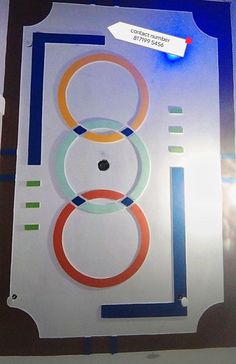 the olympic rings are on display in front of a blue background with white and red circles