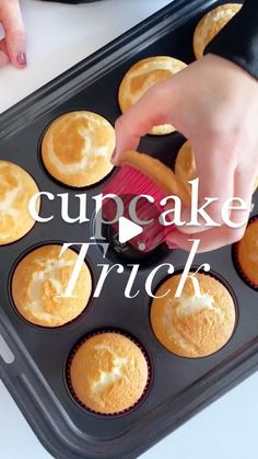 cupcakes in a muffin tin being dunked with icing