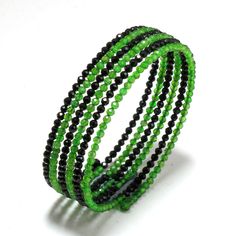 Enhance your wrist with this Elegant Chrome Diopside & Black Spinel Bangle Bracelet. Featuring vibrant green chrome diopside alongside sleek black spinel, this bangle offers a perfect balance of rich color and sophisticated contrast. Why This Bracelet Stands Out Lush Chrome Diopside: The vivid green stones bring a fresh, vibrant touch that energizes your look. Sleek Black Spinel: The deep black spinel adds a touch of elegance and creates a striking contrast with the green diopside. Refined Design: The bangle's clean lines and carefully arranged stones provide a modern and chic aesthetic that complements any outfit. Make a bold statement with this exquisite bangle, where the vibrant green of chrome diopside meets the elegant sophistication of black spinel. ★ You are seeing actual pics of pr Bracelet Stands, Black Spinel Necklace, Wrap Bangles, Green Chrome, Spinel Gemstone, Natural Gemstone Jewelry, Bead Bangles, Bangle Designs, Black Spinel