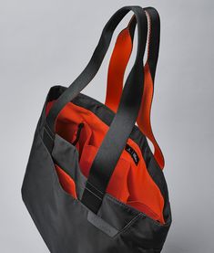 A must-have accessory for carrying all of your essentials. Whether you're running errands or enjoying some time by the sea, the Elements Tote is perfect for any occasion. Its foldable design makes storage a cinch and lets you bring it along wherever life takes you. Made with durable and high-quality materials, this tote can withstand daily wear and tear. Its simple yet stylish look will fit in anywhere, making it a great choice for everyone. Comfortable & sturdy strap handles Magnetic closure Qu Black Packable Travel Accessories For Everyday Use, Functional Foldable Bags For Everyday Use, Everyday Foldable Functional Bag, Functional Foldable Bag For Daily Use, Functional Foldable Everyday Bags, Casual Foldable Bags For Outdoor Activities, Packable Black Travel Accessories, Sporty Travel Accessories With Functional Pockets, Black Sporty Travel Accessories For Outdoor