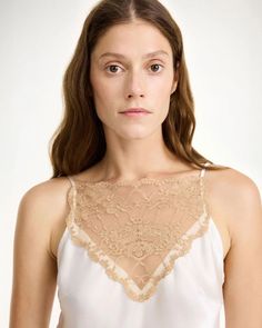 The Leeba Top in Soft White by By Malene Birger is a delicate, silk camisole featuring lace details and adjustable straps. 76% Acetate, 24% Polyester Q70365018 Feminine Silk Camisole With Built-in Bra, Chic Lace Cami Top With Built-in Bra, Chic Wedding Night Camisole, Sleeveless Evening Slip Dress With Delicate Lace, Summer Cami Slip Dress With Delicate Lace, Chic Lace Slip Dress With Delicate Straps, Lace Slip Dress With Delicate Straps For Daywear, Elegant Tank Top With Lace Trim For Party, Chic Lace Trim Camisole For Daywear