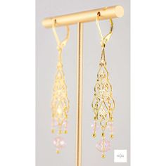 You will look so pretty in these Pink Glass Filigree Drop Earrings! Enhance your beauty with these Pink Glass Filigree Earrings! Sweet and elegant these stunning earrings are a must-have for any wardrobe, featuring lovely faceted pink briolette glass beads, micro-faceted white glass beads, and gold seed beads. The gold-plated filigree and lever backs add a touch of elegance to these 2.75 inch long earrings. Perfect for adding a touch of romance and charm to your look, these gold filigree dangle Gold Crystal Earrings With Dangling Beads For Wedding, Rose Gold Filigree Dangle Jewelry, Pink Elegant Beaded Earrings For Celebration, Elegant Pink Beaded Earrings For Celebration, Delicate Gold Earrings With Dangling Beads, Elegant Gold Crystal Earrings With Dangling Beads, Elegant Pink Dangling Beads Earrings, Elegant Pink Chandelier Earrings With Dangling Beads, Delicate Gold Chandelier Earrings For Party