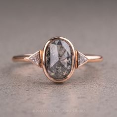 a close up view of a fancy ring with an oval cut diamond in the center