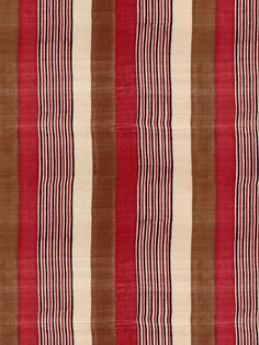 a red and brown striped rug with vertical stripes