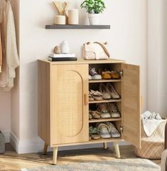 a wooden cabinet with shoes on it in a room