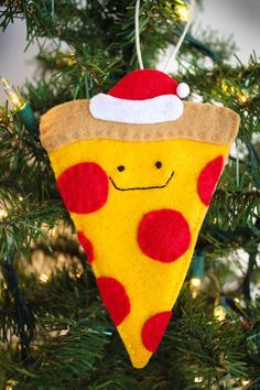 a christmas ornament hanging from a tree with a slice of pizza on it