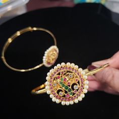 'Bajuband' or Armlet is a type of bracelet worn on the upper part of the arm. Armlets create a style statement for women in present times. Besides being wedding jewelry, armlets are also fashion jewelry. Armlets are the aptest accessory for weddings, engagements, theme parties, and religious occasions. Dainty armlets look beautiful when worn with lehengas, saris, or any sleeveless traditional attire. Stonework design (W x H): 1.5 x 1.5 inches. inner circumference : 8 inches Material: Bright gold Elegant Openable Bracelets For Puja, Elegant Openable Bracelet For Puja, Elegant Bangle For Navratri, Elegant Bracelets For Wedding And Navratri, Elegant Bracelets For Puja And Festivals, Elegant Bangle Bracelet For Navratri, Elegant Openable Jewelry For Puja, Navratri Wedding Bracelet Jewelry, Elegant Bracelets For Navratri Gift