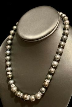 Diamond Tahitian Pearl Necklace 18k Gold 12.9 mm 18" Certified $12,250 821384 This fine piece of jewelry is designed by Ezra Kassin! DETAILS 14 KT SOLID WHITE GOLD RONDELS 18 KT SOLID WHITE GOLD CLASP (Clasp Stamped 750) 12.90-10.00 IN 75.809 Grams Total Weight Quality Grade: AA (High) Color: Gray Overtone: Silver & Peacock Surface: Lightly Blemished Luster: High 39 Large GrayTahitian Pearls 72 Single Cut Diamonds The Gray Tahitian Pearls Have A Silver & Peacock Overtone What a glamorous Luxury Tahitian Pearl Jewelry With Diamond Accents, Luxury Tahitian Pearl Jewelry With Brilliant Cut, Akoya Pearl Earrings, Diamonds And Pearls, Tahitian Pearl Necklace, Pearl And Diamond Necklace, Alumni Association, Akoya Pearls, Tahitian Pearls