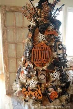 a halloween tree decorated with black and orange decorations