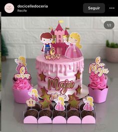 there is a cake and cupcakes with princess decorations on it in the table