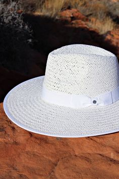 Our Palm Desert Panama fit in perfectly on our latest road trip photo shoot. Stunning, classic, chic - everything you've ever wanted in a hat. Featuring a molded crown with a pinched 10cm brim and hand woven straw, it's crystallized on the tone on tone ribbon with a simple Swarovski rivet. - 4" brim - Adjustable inner drawstring for custom sizing Elegant Panama Straw Hat With Upf 50+, Elegant Straw Panama Hat With Upf 50+, Elegant Fedora With Upf 50+ For Travel, Elegant Fedora With Upf 50+ And Curved Brim, Classic Wide Brim Fedora With Upf 50+, Elegant Fedora For Kentucky Derby Upf 50+, Elegant Straw Hat With Upf 50+, Classic Woven Straw Hat For Kentucky Derby, Elegant Brimmed Panama Hat With Upf 50+